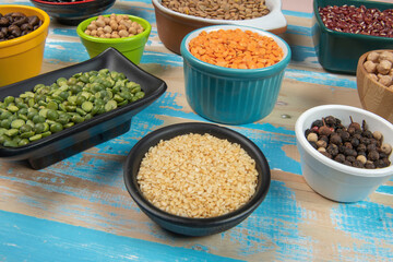 assorted bowls with raw grain and seeds top view
