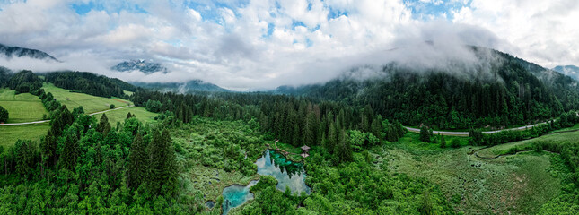 Zelenci Nature Reserve in Slovenia. Mountain wetlands with spring-fed turquoise lake , rare plants & wading birds. Aerial drone view.
