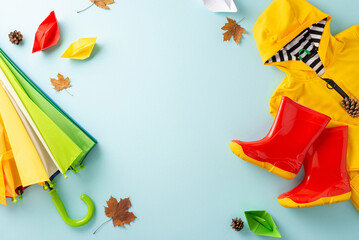 Exciting rainy day scenario in autumn for kids. Top-down image featuring a colorful umbrella,...