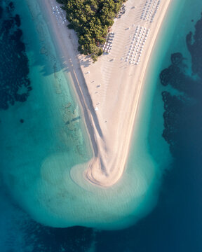 Aerial view of beautiful white sand beach surrounded by blue waters
