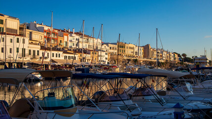 Boats line the picturesque marina port harbor at Ciutadella de Menorca, on the Balearic island of Menorca in the Mediterranean Sea.
