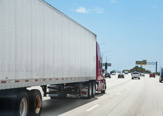 fast delivery USA truck on the highway in big, modern city. cargo transport vehicle.