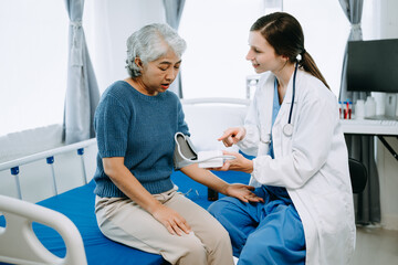 Fototapeta premium Woman Doctor and patient discussing something while sitting on examination bed in modern clinic or hospital . Medicine and health care concept.