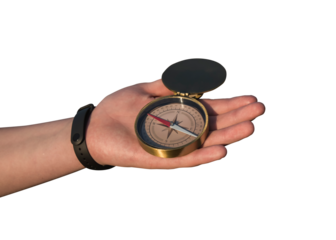 Kompas pokazujący kierunki świata na wyciągniętej dłoni, bez tła.