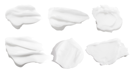 A set of different strokes of white cream on a blank background. PNG
