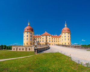Fototapeta na wymiar Moritzburg, Saxony, Germany - July 7, 2023: Famous ancient Moritzburg Castle, near Dresden at sunny summer day with blue sky