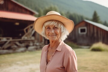 Lifestyle portrait photography of a tender old woman wearing a trendy bikini and straw hat against a mountain cabin background. With generative AI technology