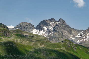 Steinige, steile Berge zwischen Tirol und Vorarlberg, Österreich, mit Schnee im Sommer und grünen Weiden aus dreistufiger Almwirtschaft. Wunderschönes Gebiet zum Klettern und Wandern, Erholung pur 
