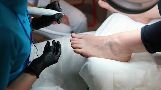 Professional pedicure master files nails , preparation for polishing with shellac pedicure.