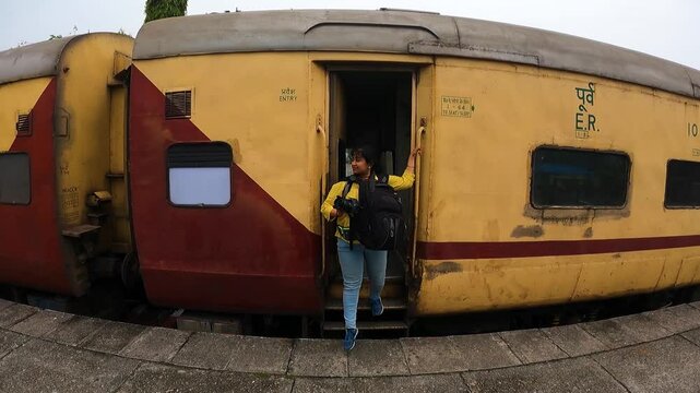 5th April, 2022, New Mal Junction, West Bengal, India: A female solo traveler coming down from a Train at New Mal Junction station.