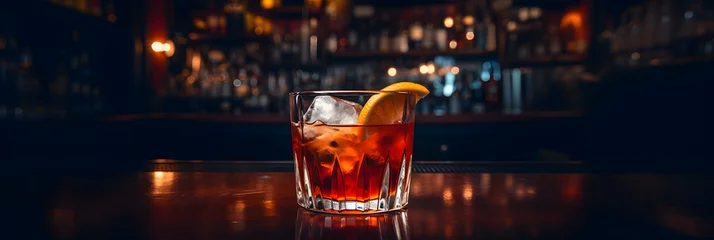 Fotobehang Old-fashioned drink at bar with a slice of orange, cherry and ice, a classic alcoholic drink © rodrigodm22