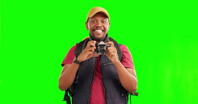 Travel, camera and green screen with a black man backpacker hiking or sightseeing for photography. Portrait, adventure and smile with a happy young male tourist taking a picture on chromakey mockup