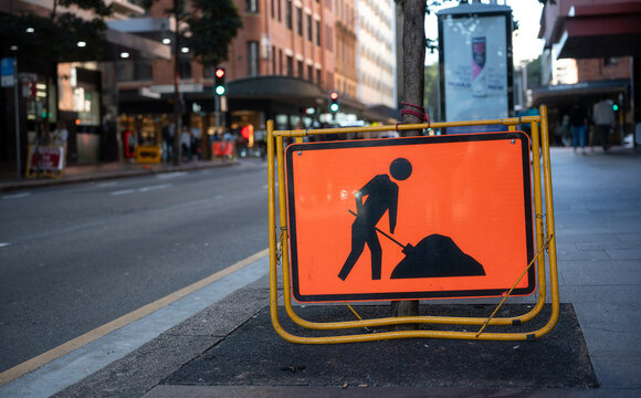 Roadwork Ahead Sign Located On Street Side In Tne City, Driving Carefullly Attention For Road Drive Safety