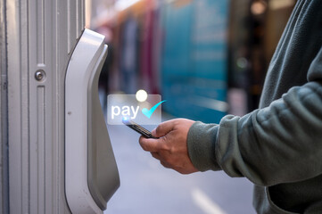 man using smartphone tap to pay at pay station for  ticket or transportation services, buy and scan to pay