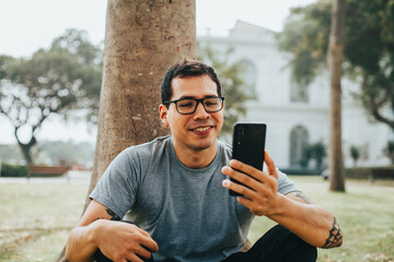 Portrait photography of a young man in video call from his phone. Concept of people, communications...
