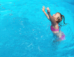 Little Girl Playing in a Swimming Pool - Pulling the Water Up - Water Splash