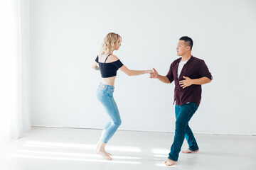 bachata Latina man and woman dancing in the hall of kizomba studio