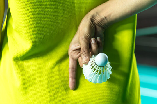 Close up Badminton player hand holding shuttercock in the back, Badminton sports