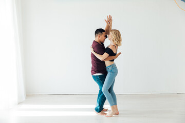 a man and a woman dance in the hall of the studio kizomba bachata Latina