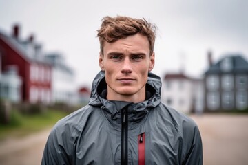 Close-up portrait photography of a satisfied boy in his 30s wearing a lightweight windbreaker against a historic colonial village background. With generative AI technology