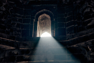 Beam of light from window of ancient indian tomb Bada Gumbad in New Delhi, India, beautiful white...