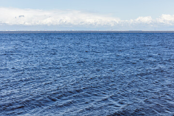 Baltic Sea view, blue water is under cloudy sky on a daytime