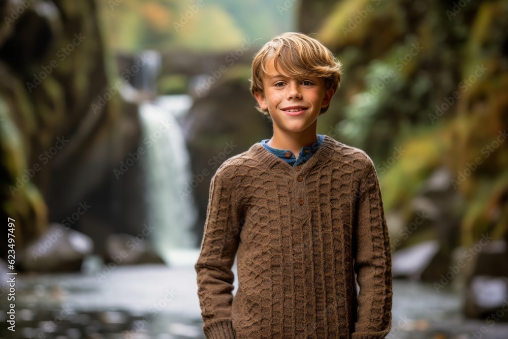 Sticker Editorial portrait photography of a joyful kid male wearing a cozy sweater against a picturesque waterfall background. With generative AI technology