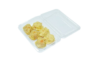 steamed Chinese dumpling filling mashed pork and shrimp topping crispy fried garlic or dim sum dipping soy sauce on plastic packaging isolated white background