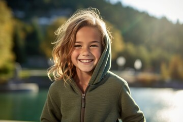 Environmental portrait photography of a grinning kid female wearing a cozy zip-up hoodie against a scenic hot springs background. With generative AI technology