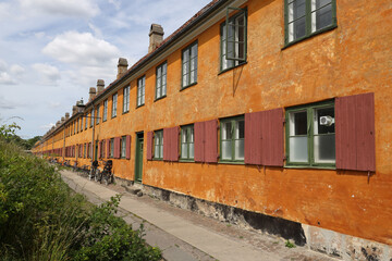 Fototapeta na wymiar Characteristic yellow terraced houses in the historic district of Nyboder in Copenhagen