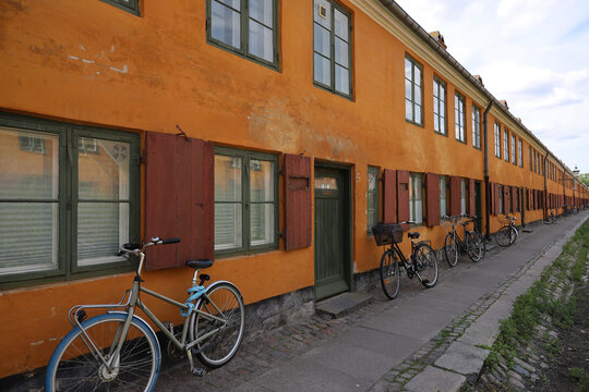 Characteristic yellow terraced houses in the historic district of Nyboder in Copenhagen