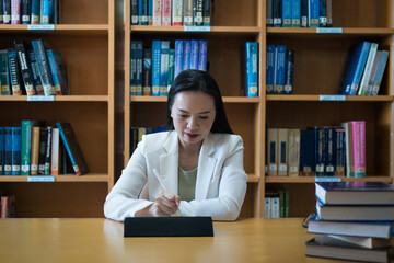 Female university lecturer working in library