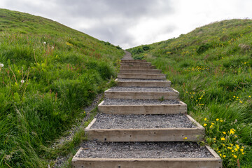 Obraz premium Trail of steps leading up the hill to Sugandisey Island Lighthouse in Stykkisholmur Iceland