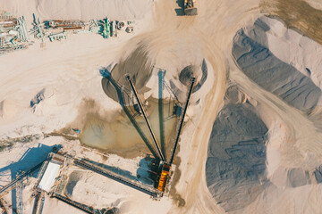 Quarry mining, work of the excavator and dump trucks, photo from the air