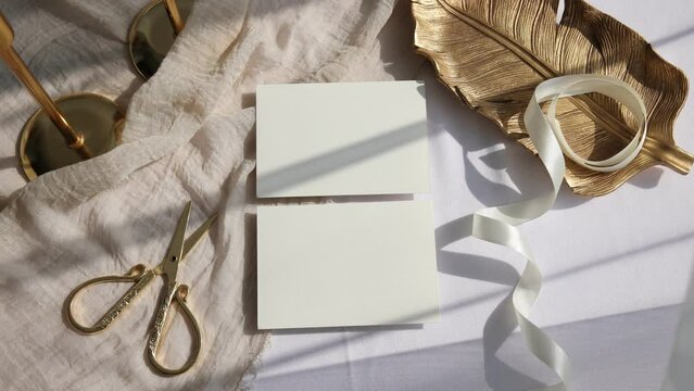 Video two RSVP cards mockup with golden plate on beige background 