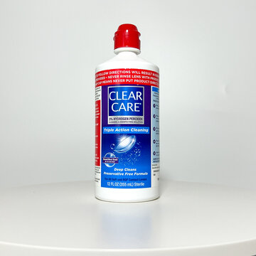 A bottle of Clear Care Contact Cleaning  Solution on a white background.