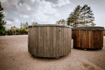 Wooden hot tub is filled with water on outdoor