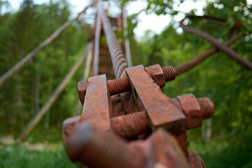 Old Rusty Metal Bolt, suspension bridge in the Oleniye Ruchiye Nature Park in the Sverdlovsk region