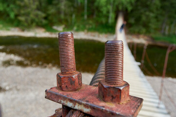 Old Rusty Metal Bolt, suspension bridge in the Oleniye Ruchiye Nature Park in the Sverdlovsk region