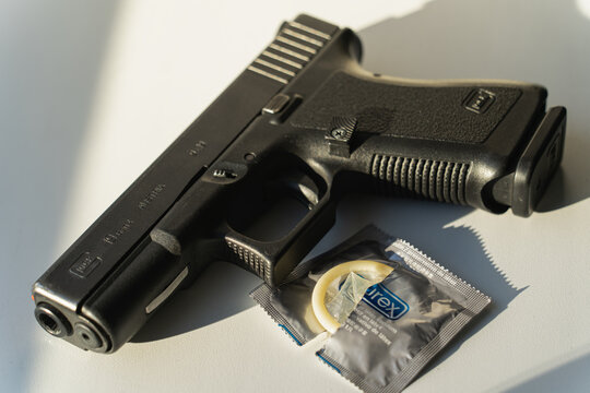 Baltic States, July 13, 2023.  A Glock 19 pistol and an open pack of DUREX condoms.