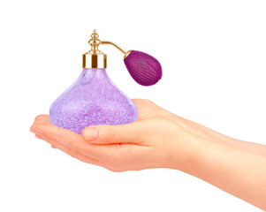 Beautiful female hands holding a bottle of perfume