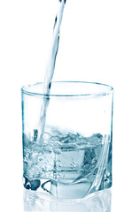 pouring water on a glass on white background