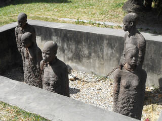 Last slave market in Africa memorial has statues of slaves in chains in Stone Town in Zanzibar...