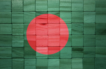 colorful painted big national flag of bangladesh on a wooden cubes texture.