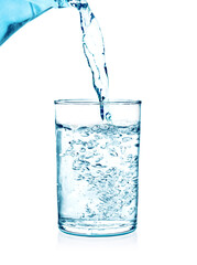 pouring water on a glass on white background