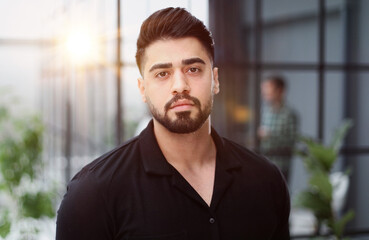 Young handsome businessman in a black shirt.