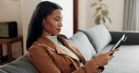 Woman, tablet and relax on sofa in living room for streaming online movie, ebook subscription or reading blog. Young female person on couch with digital technology, social media or search web at home - Powered by Adobe