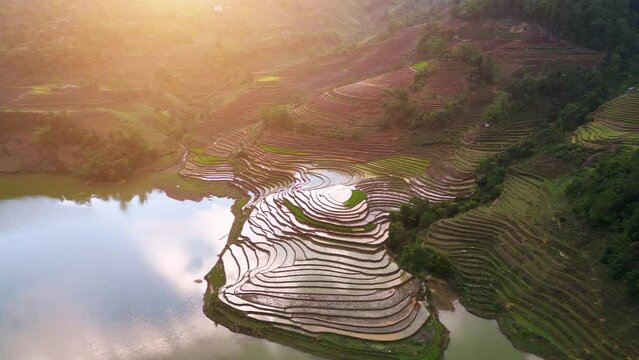 Aerial view of the water season makes the terraced fields of Y Ty commune, Lao Cai province, Vietnam appear with brown soil blending with the beautiful sky.
