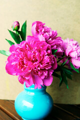 bouquet of flowers pink peonies in blue vintage vase