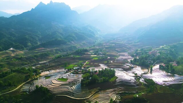 Aerial view of the water season makes the terraced fields of Y Ty commune, Lao Cai province, Vietnam appear with brown soil blending with the beautiful sky.